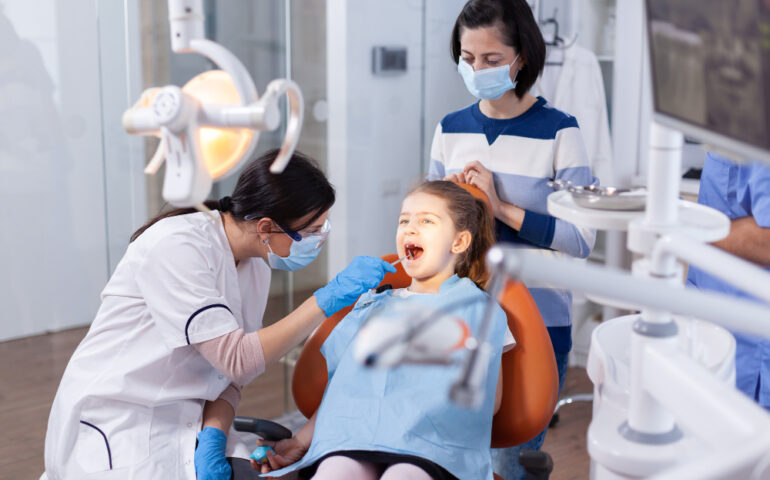 angled-mirror-used-by-dentist-doctor-little-girl-with-mouth-open-dental-office-dentistry-specialist-during-child-cavity-consultation-stomatology-office-using-modern-technology